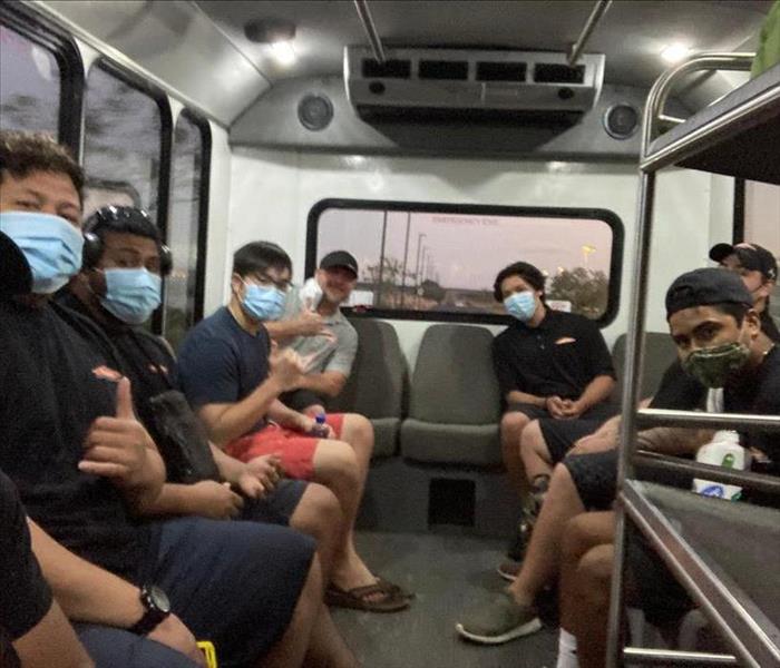 COVID-19 emergency cleaning - image of people on bus with masks on